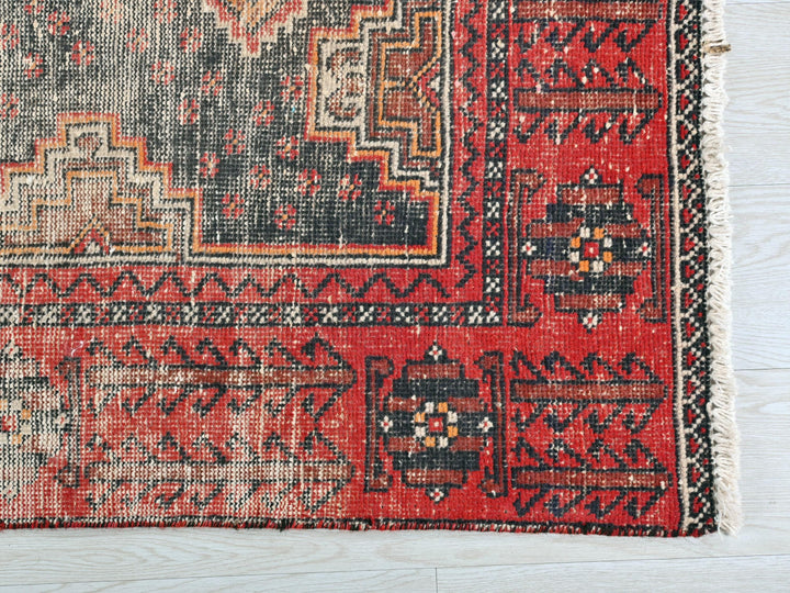 a red rug with black and white designs on it