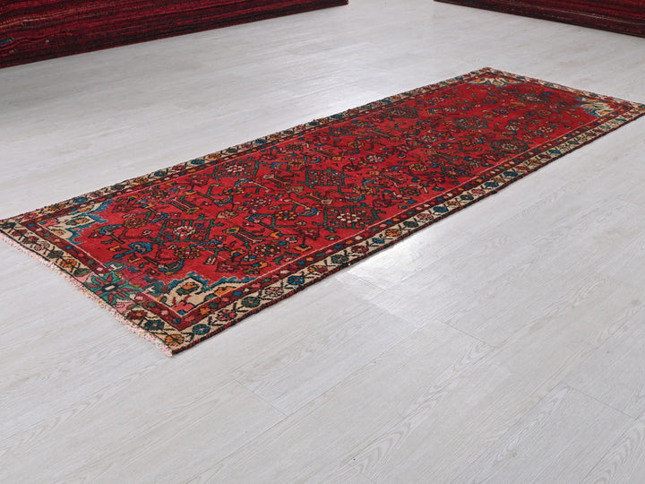 a red rug on the floor of a room