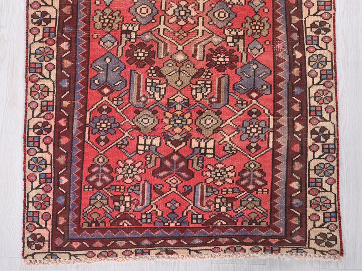 a red rug with a design on it