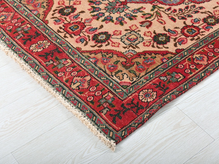 a red rug on a white wooden floor