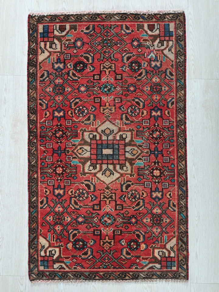 a red rug on a white wooden floor
