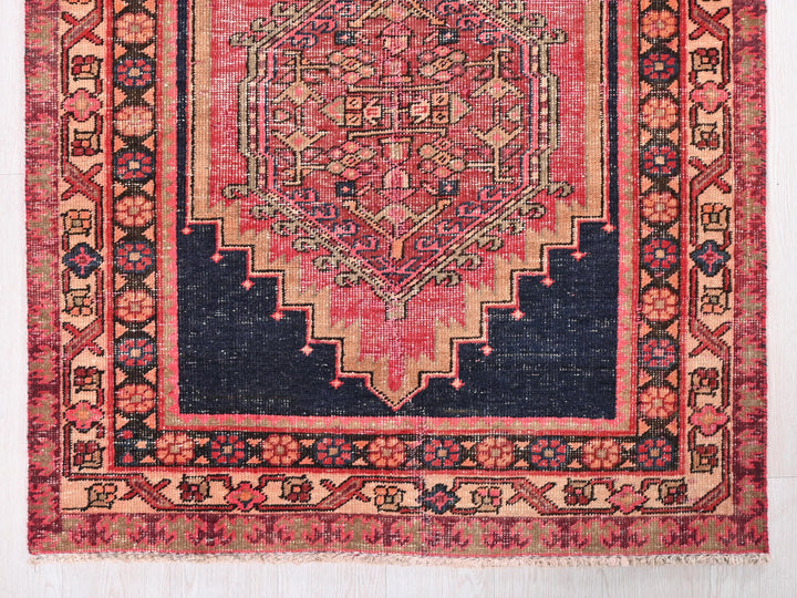a red and blue rug with an intricate design