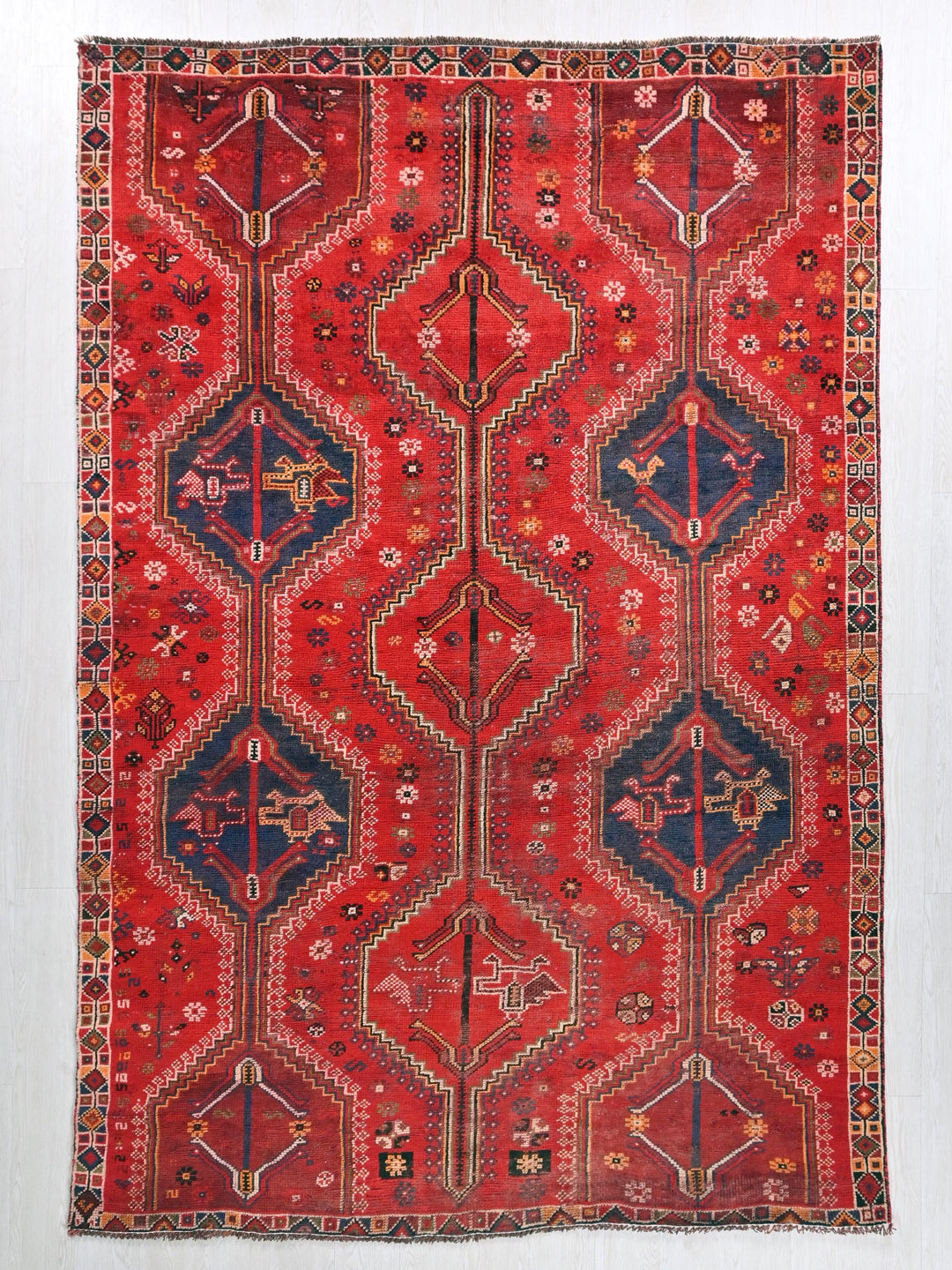 a red rug with a design on it