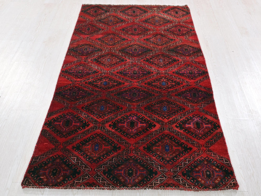a red rug on a white wooden floor