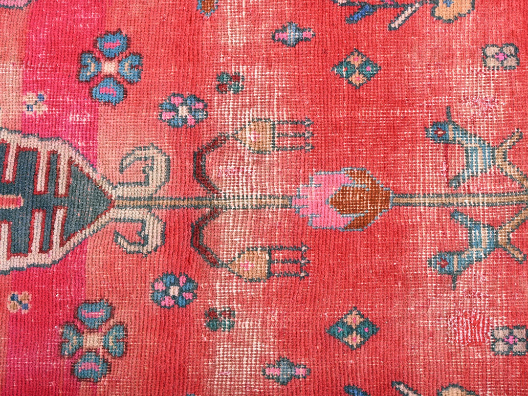 a close up of a red rug with flowers on it