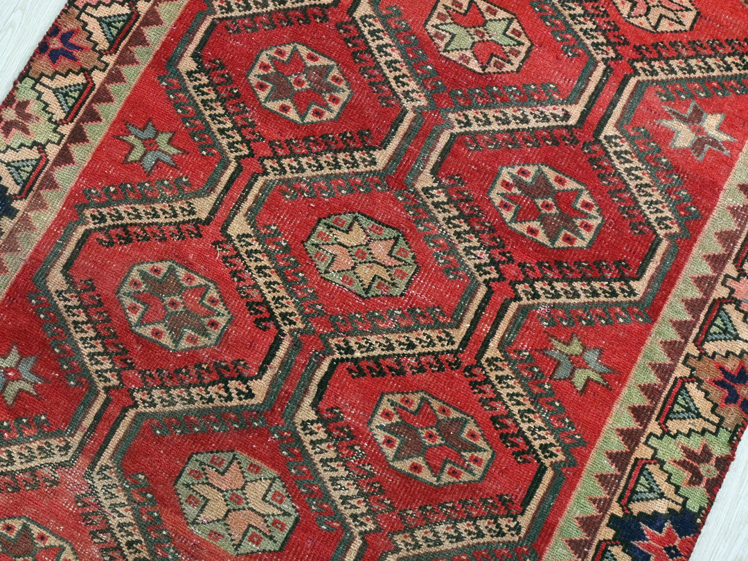 a red rug with many different designs on it