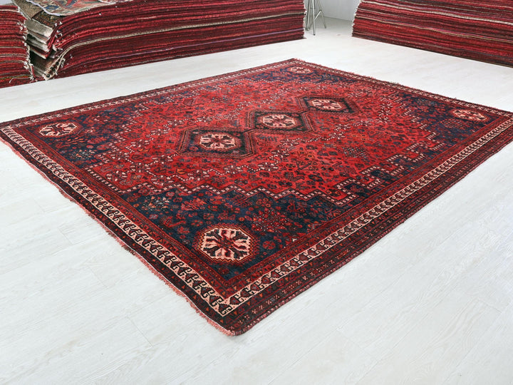 a red oriental rug on a white floor