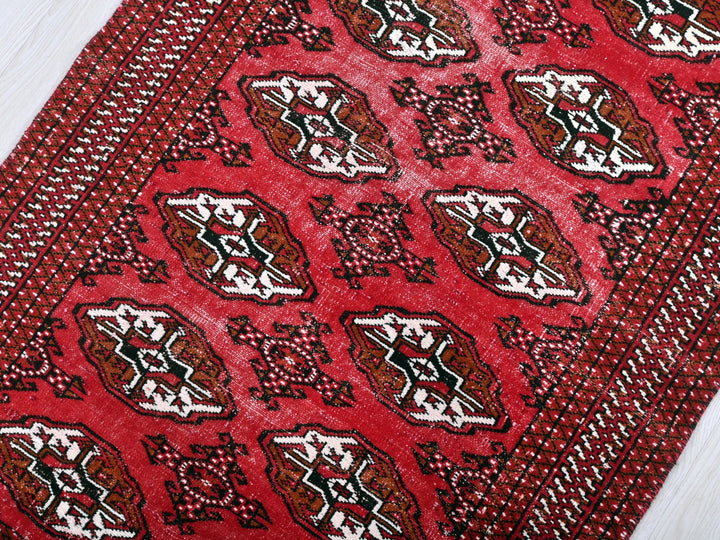 a close up of a red tie on a white surface