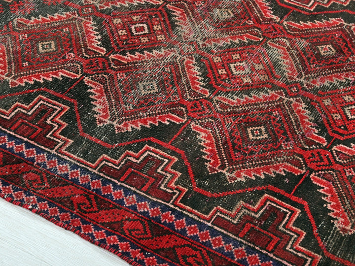 a close up of a red and black oriental rug