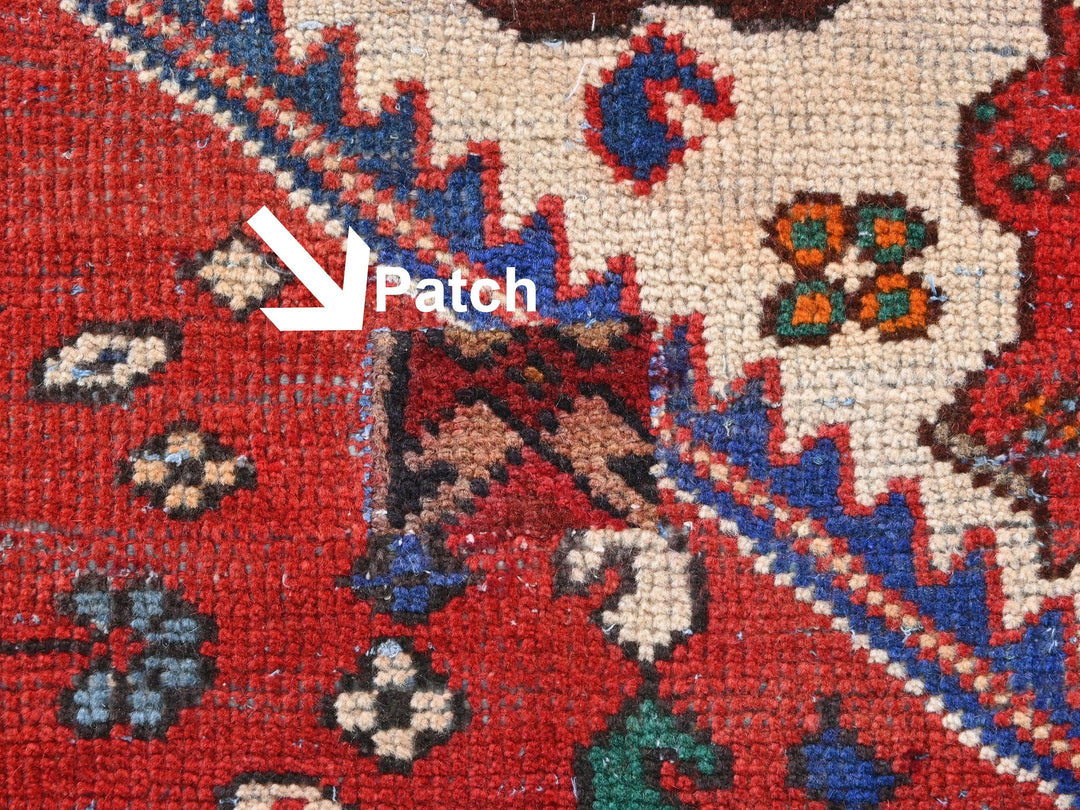 a close up of a red rug with a blue border