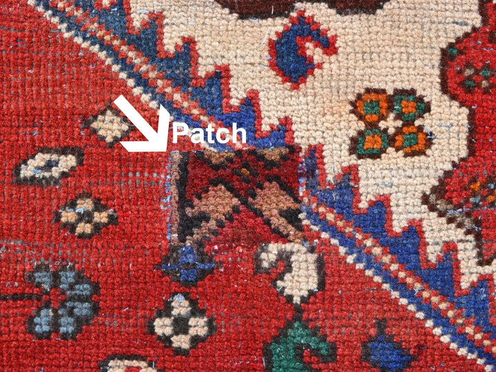 a close up of a red rug with a blue border