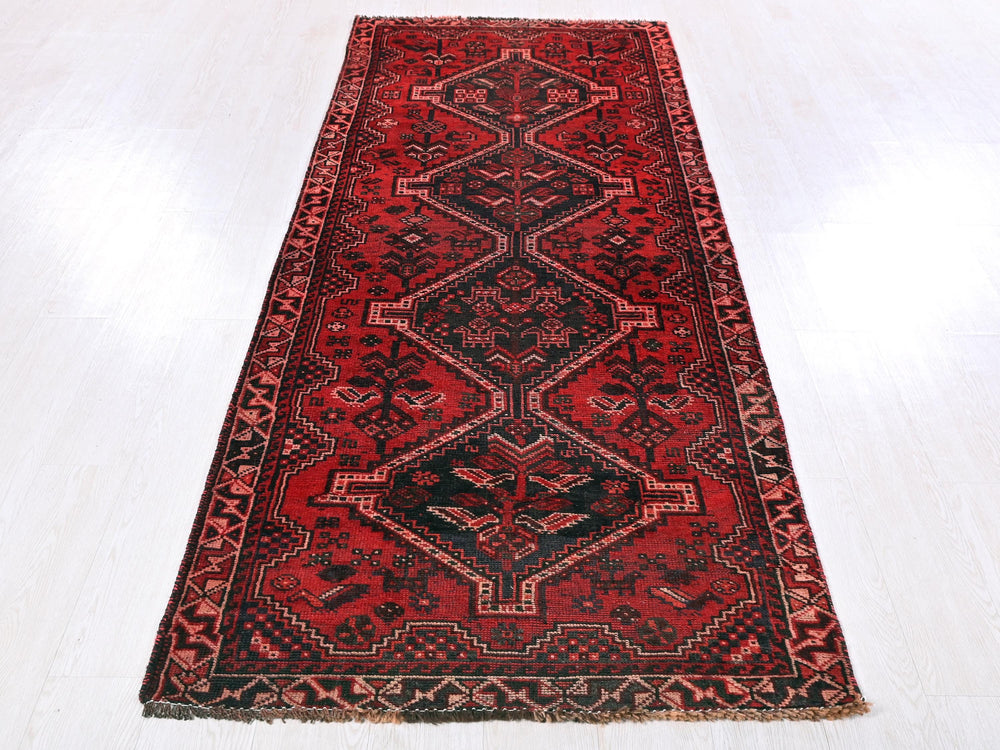 a red rug on a white wooden floor