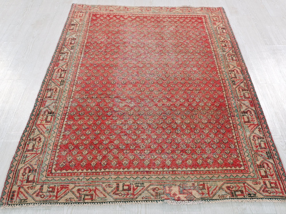 a red rug is laying on a white floor