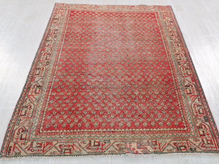 a red rug is laying on a white floor