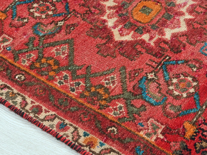 a close up of a red oriental rug
