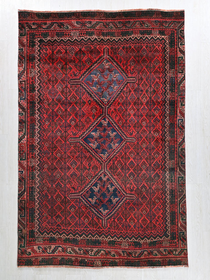 a red rug with a diamond pattern on it