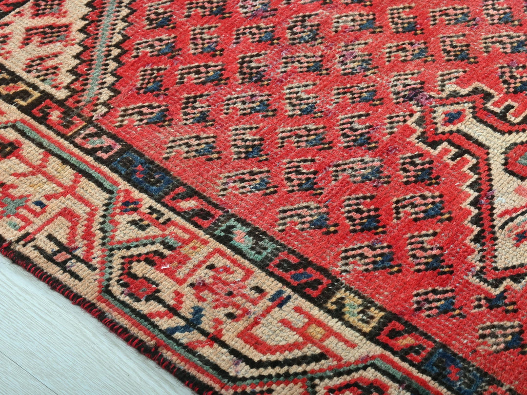a close up of a red oriental rug