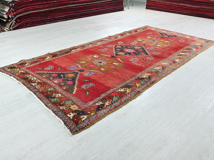 a red rug on a white floor in a room