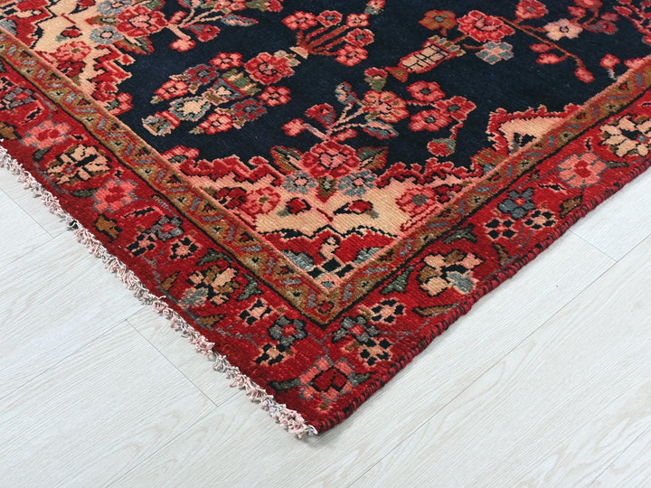 a blue and red rug on a white floor