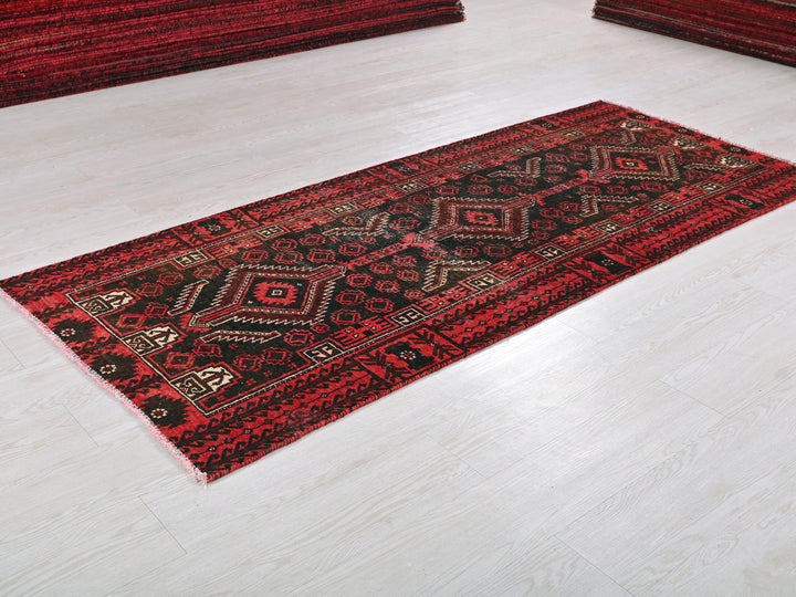 a red rug on the floor of a room