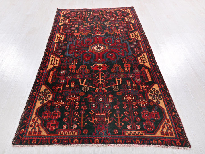 a red and black rug on a white floor