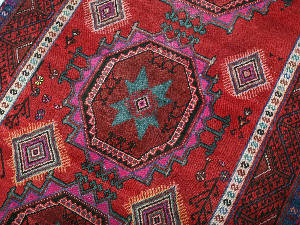 a close up of a red rug with a star on it