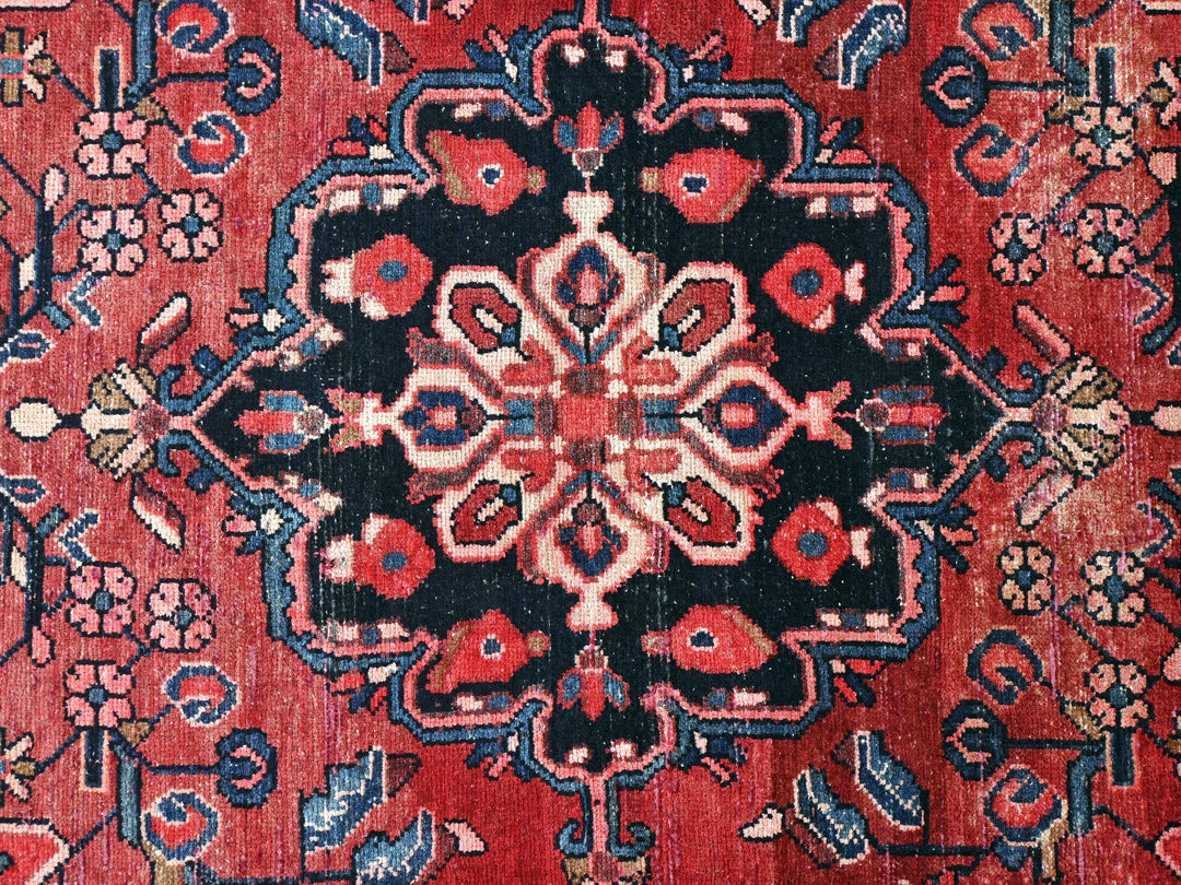 a red rug with a black and blue design on it