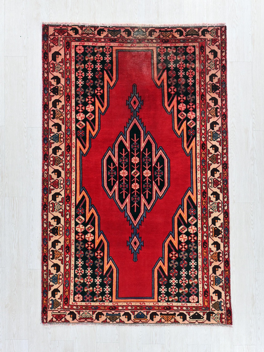 a red rug with a design on it