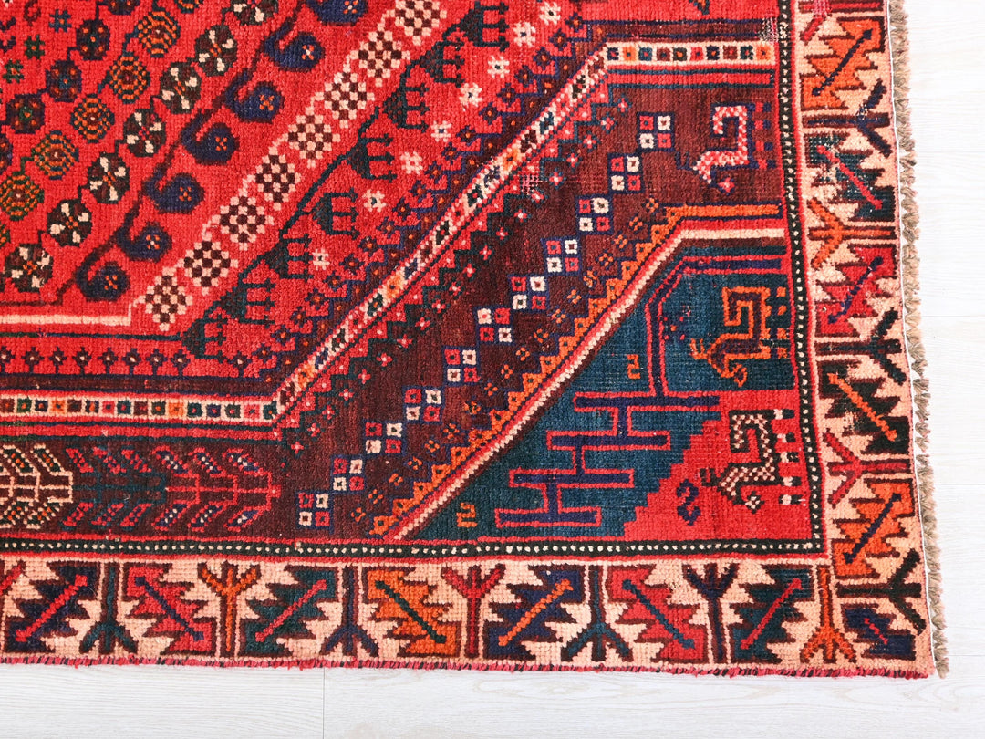a red and blue rug on a white floor