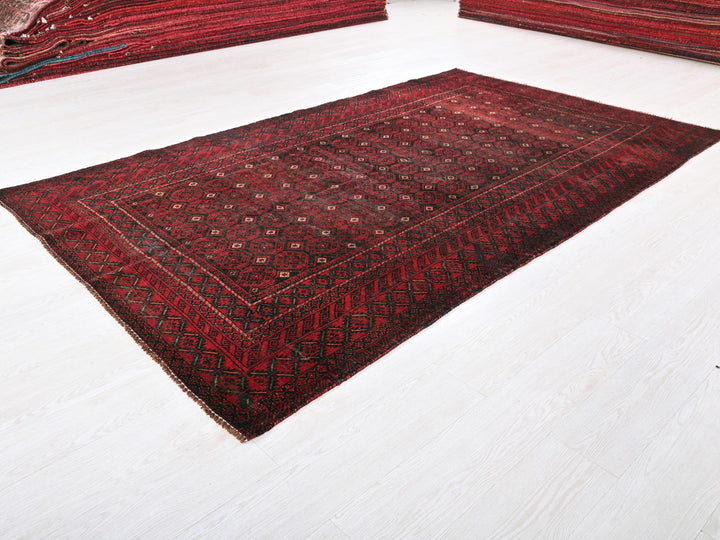 a red rug is laying on a white floor