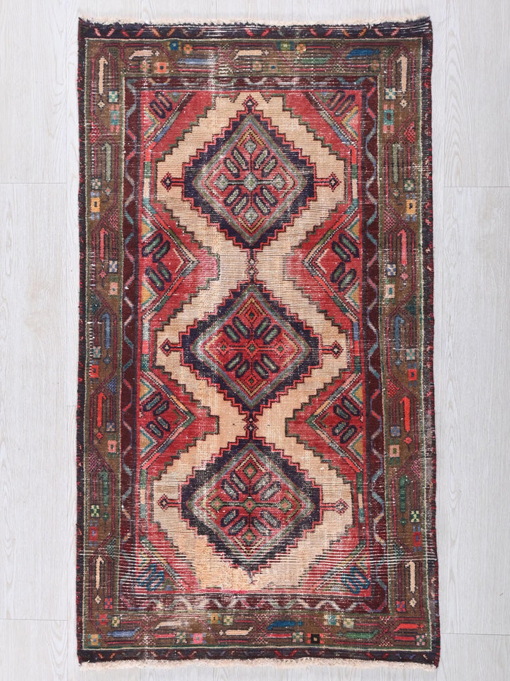 a red and blue rug on a white floor