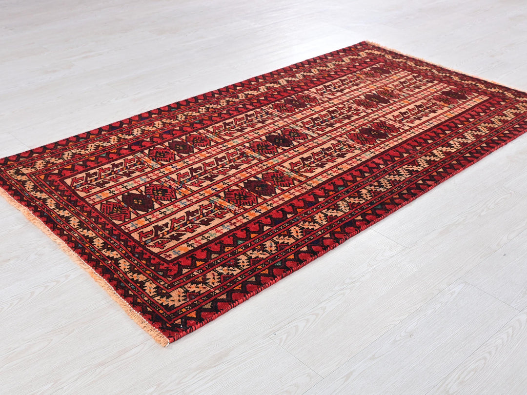 a red and black rug on a white floor