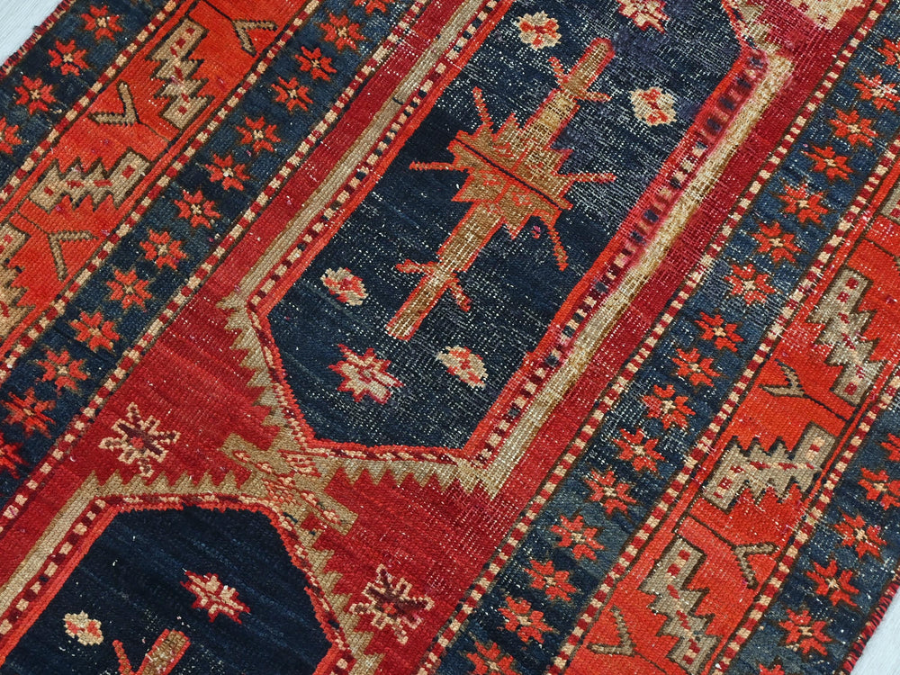 a red and blue rug with a cross on it