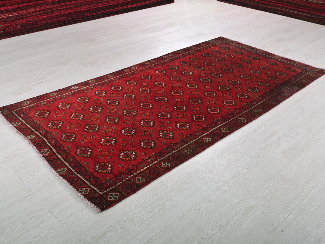 a red rug on the floor of a room