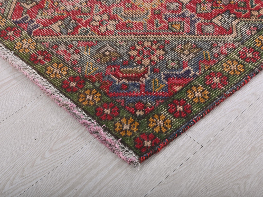 a multicolored oriental rug on a white wooden floor