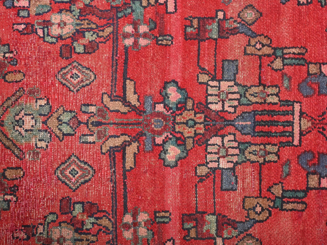 a red rug with a floral design on it