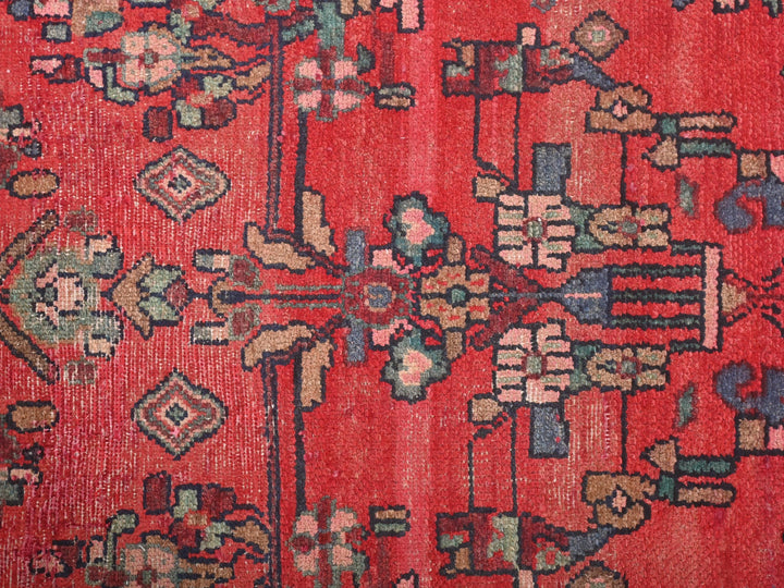 a red rug with a floral design on it