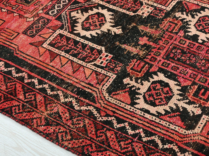 a close up of a rug on a wooden floor