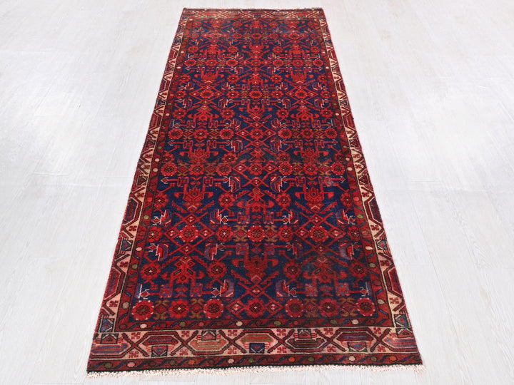 a red and blue rug on a white floor