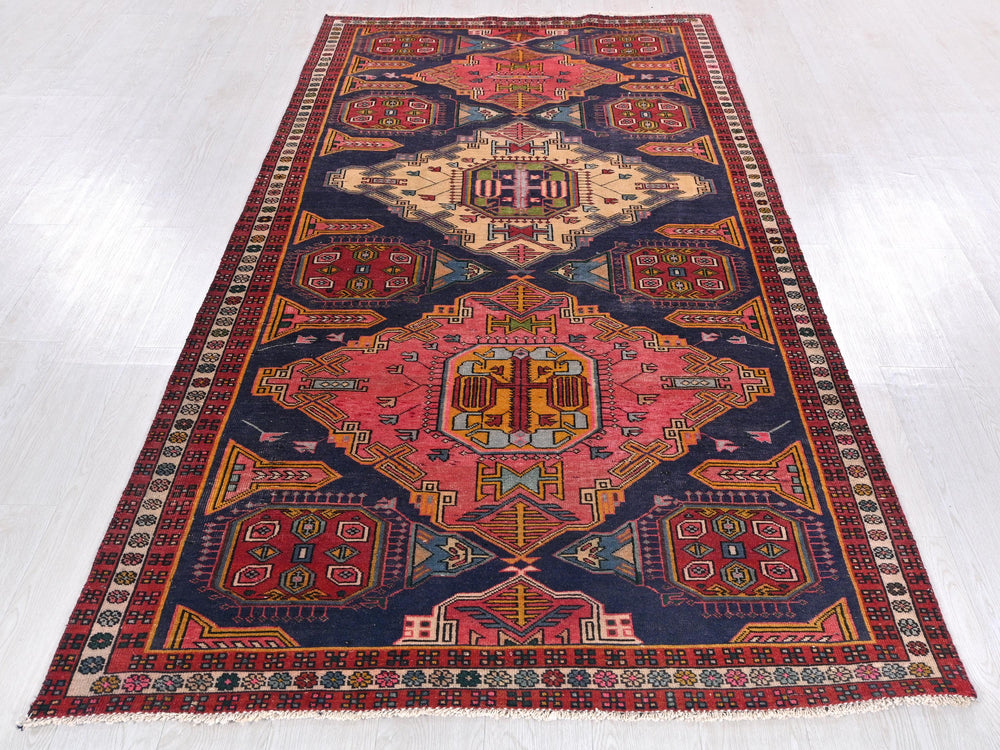 a colorful oriental rug on a white floor