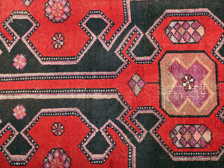 a close up of a red and black rug