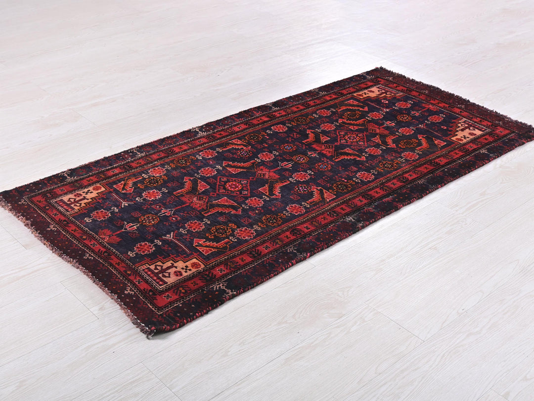 a red and blue rug on a white floor