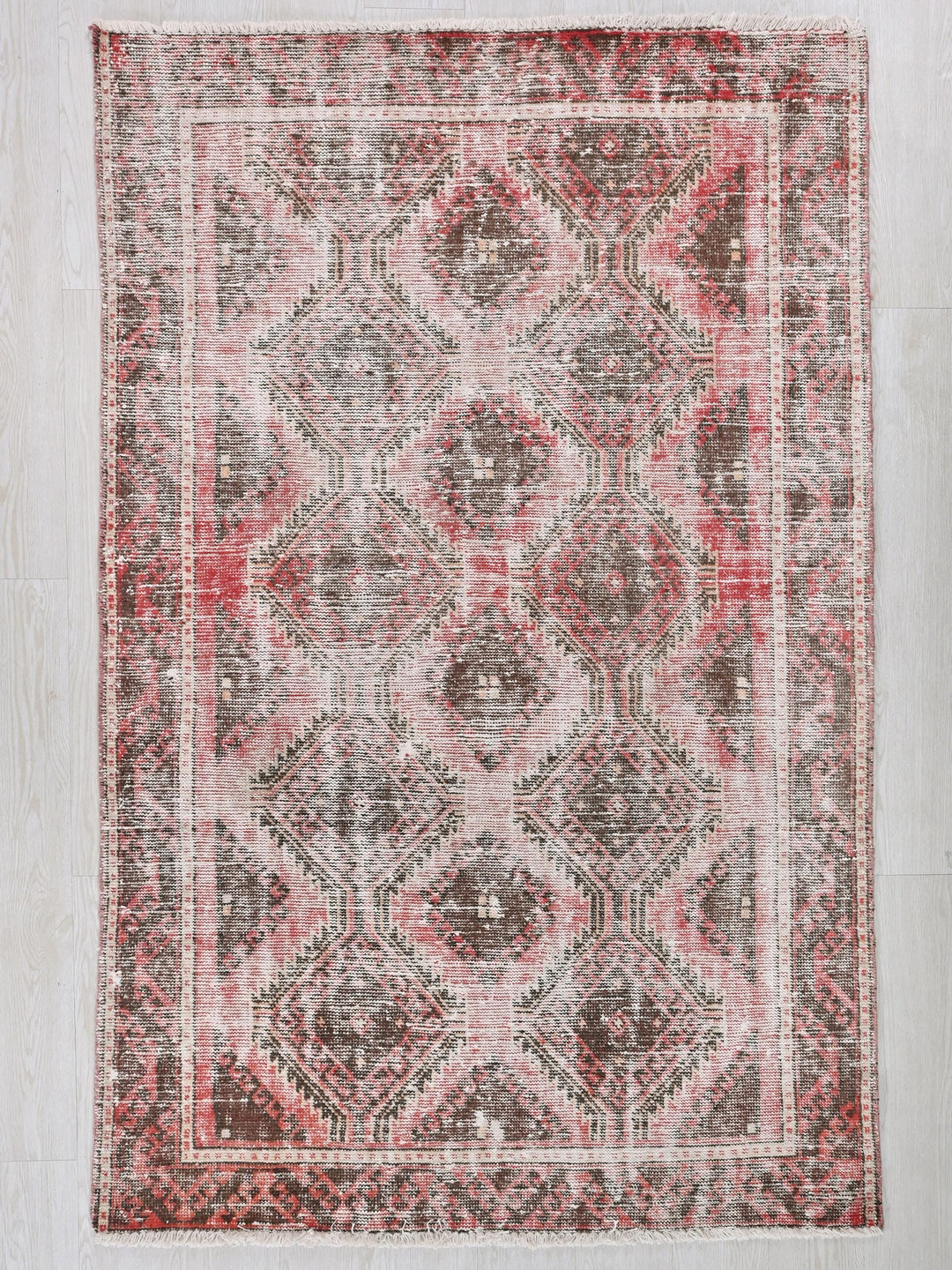 a red and gray rug on a white wall