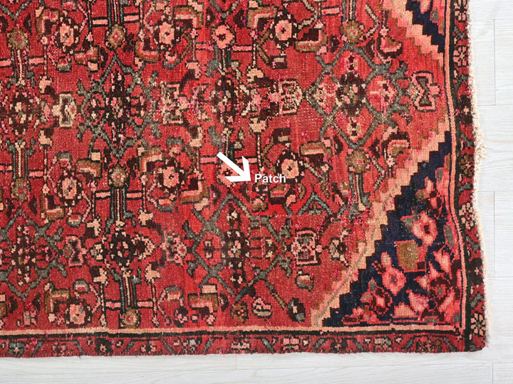 a red rug with a white arrow pointing to it