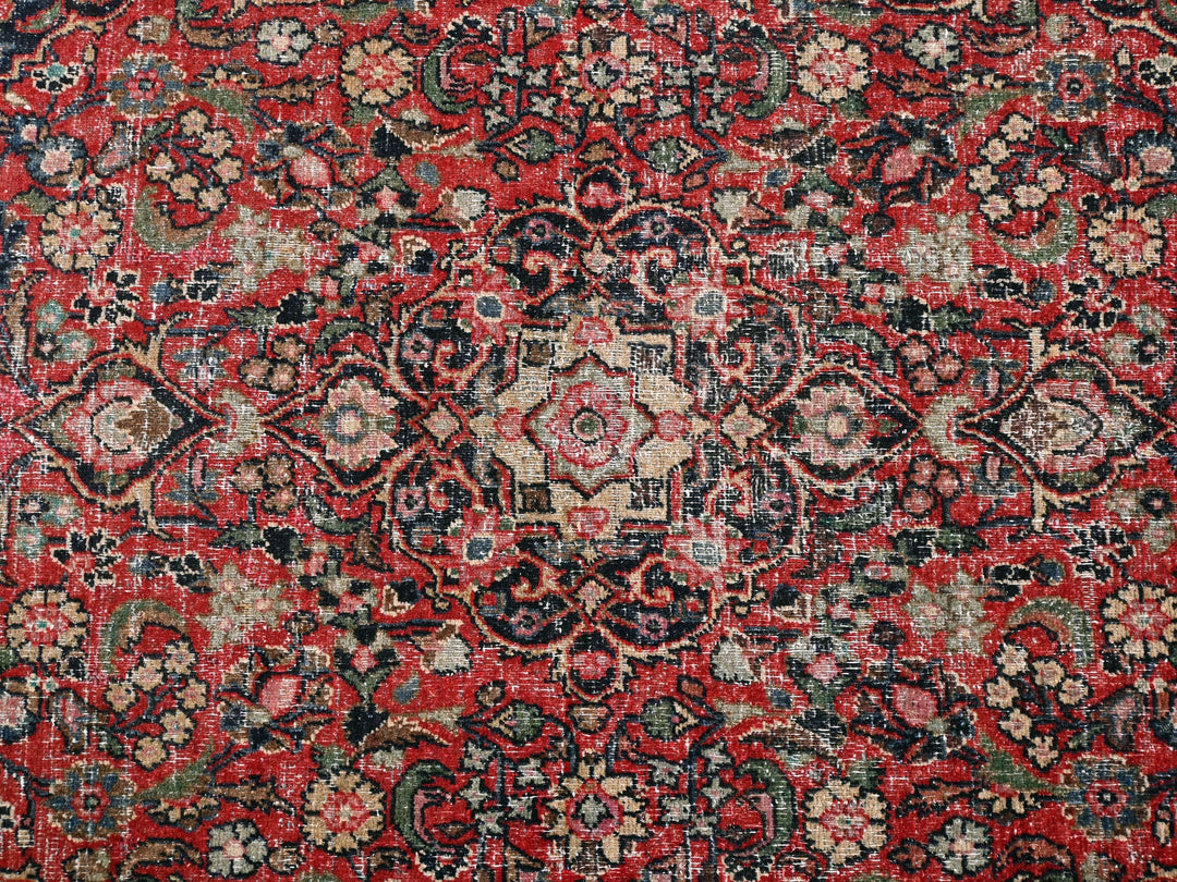 a red and black rug with a floral design