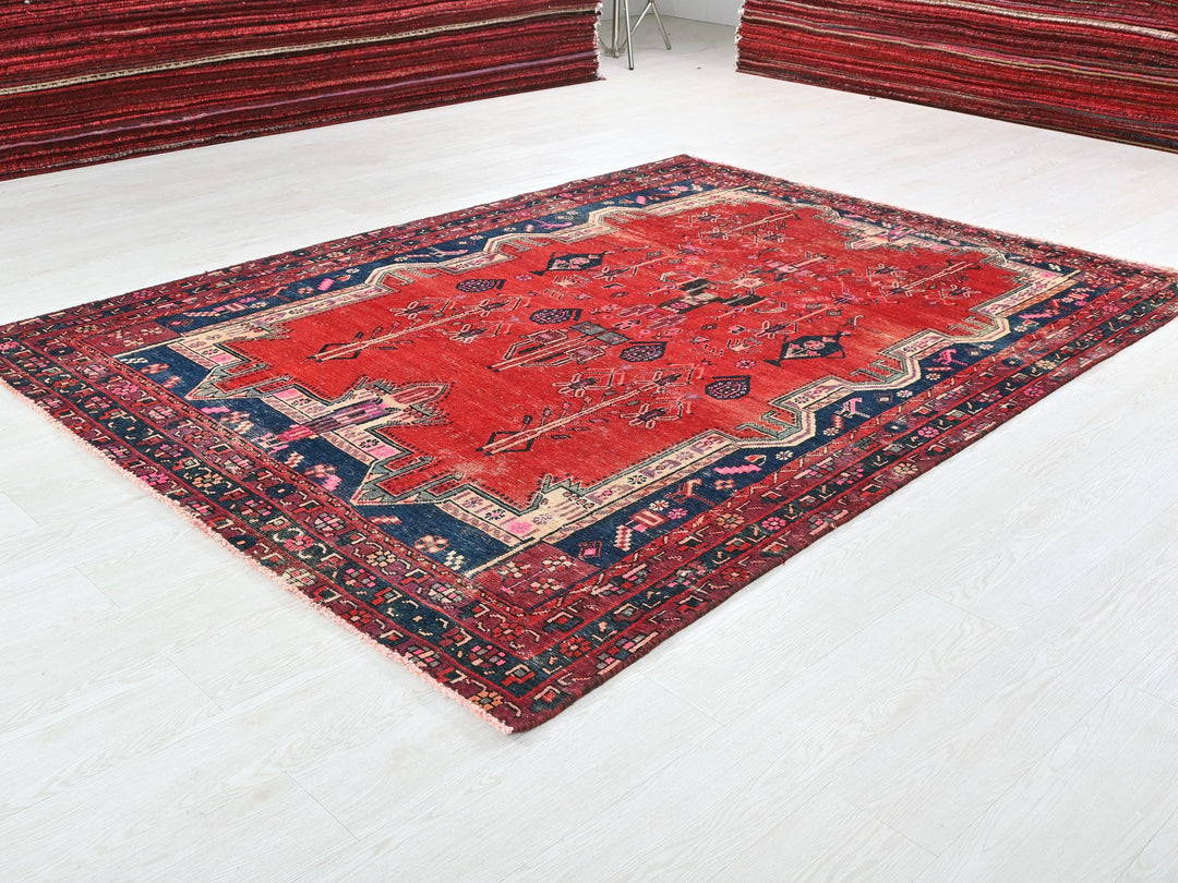 a red rug is on the floor in a room