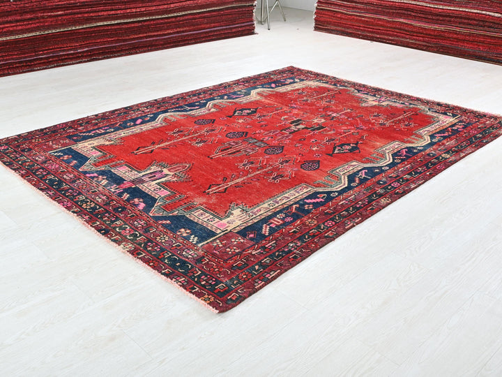 a red rug is on the floor in a room