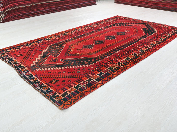 a red rug on the floor of a room