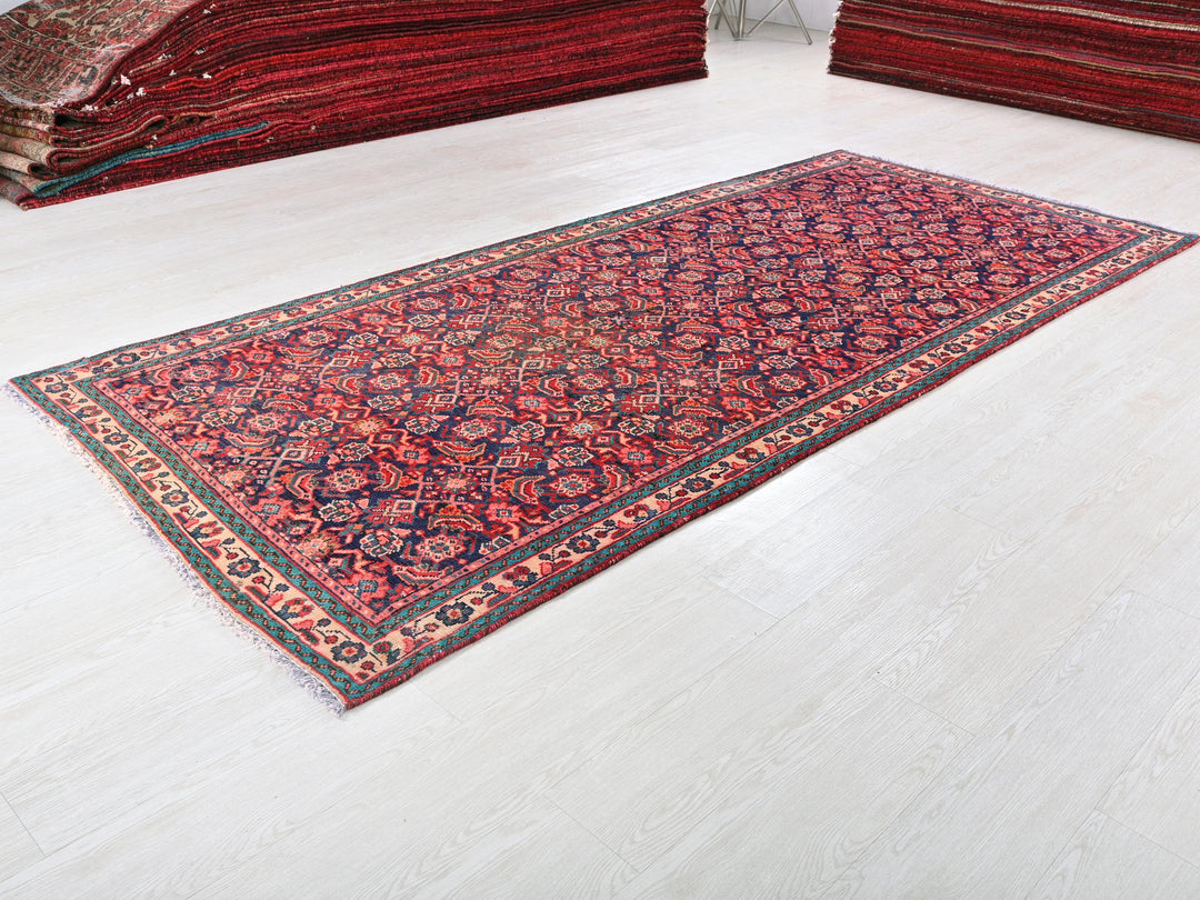 a red rug is laying on a white floor