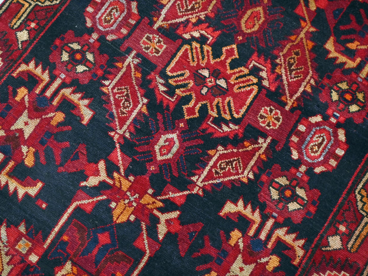 a close up of a red and black oriental rug